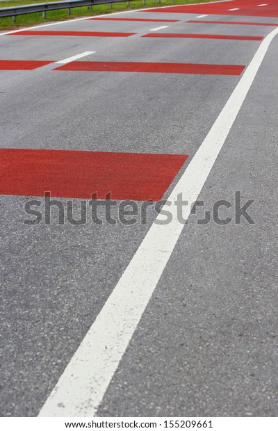 Road with white and red\
lines