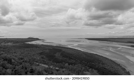 A Road Winding Through Bushland Beside A Tidal Creek Under A Stormy Sky At Conway Beach Queensland Australia