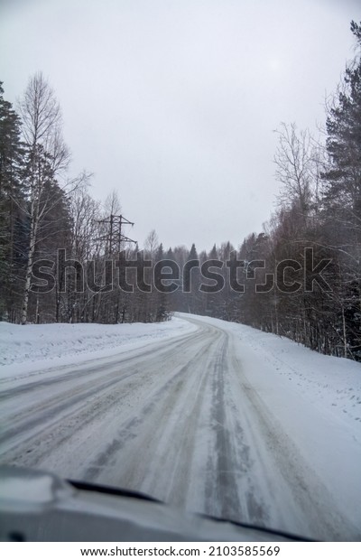 Road in winter. Concept of traveling in winter.
Concept of winter weather