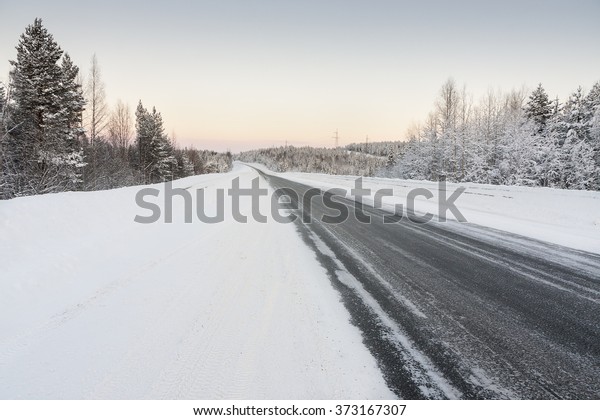 road in winter at\
dawn