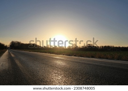 Road at winter. Sparse with snow and ice. Landscape photo. Swedish countryside. Sweden, December 2022.