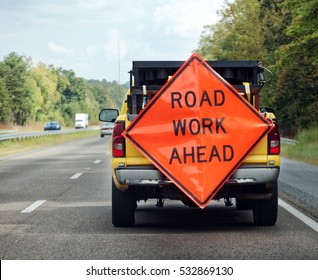 ROAD WORK AHEAD Sign Attached To Rear Of Utility Truck.