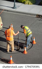 Road Work Crew Jackhammering A City Street, With Space For Text On Top