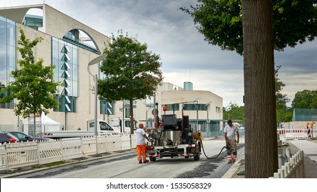 Road Work Crew With Weird Looking Machine Conduct Repairs On The Street Outside The German Chancellery Building In Berlin, Germany.  August 2019                              