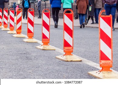 Road work. Orange traffic cones in the middle of the street. traffic safety  construction roadwork signs.Walking people.