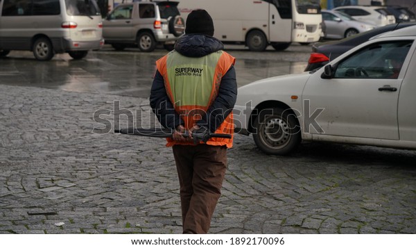 \
Road worker approaches in\
the car