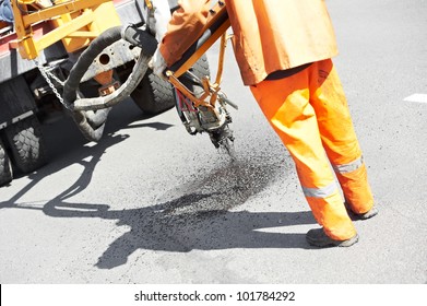 Road Worker At Asphalt Roadway Street Patching Reaparing Work