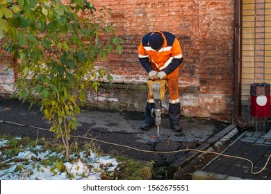 Road Worker Drilling Asphalt On Pavement With Jackhammer