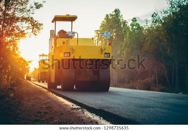 Road works in the city.\
Working on special equipment cut off the old asphalt on a Sunny\
summer day