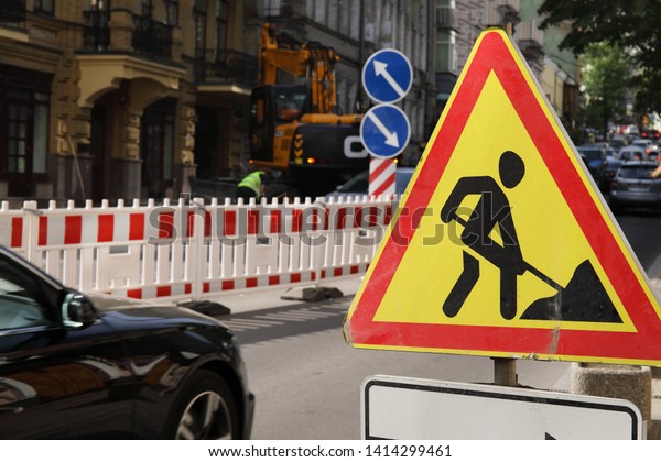 Road\
works sign for reconstruction works in\
progress