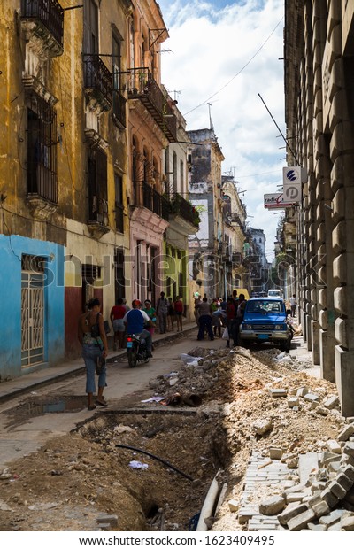 Road works taking place on a narrow road in\
the Cuban capital, Havana in August\
2014.
