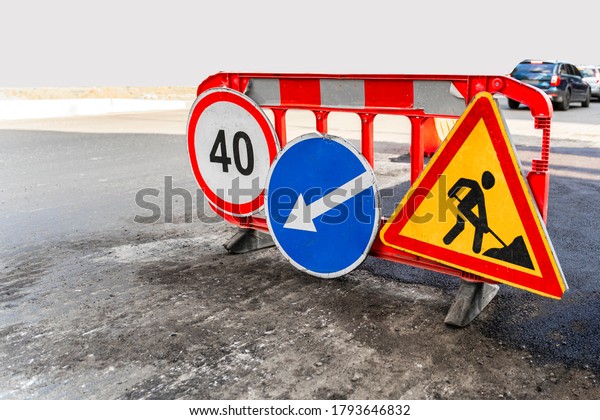 Road works traffic sign at the city\
street. Direction of detour, sign speed limit 40 and roadworks Road\
under construction\
