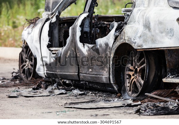 Road wreck accident or arson fire burnt wheel car\
vehicle junk