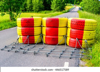 Roadblock Made Of Yellow And Red Painted Car Tires. Bridge Behind Is Getting New Railings For Improved Safety.