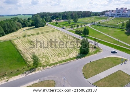Roads and field, top view. In the background is Kosovo Castle. They mowed the grass from the field, the grass is drying