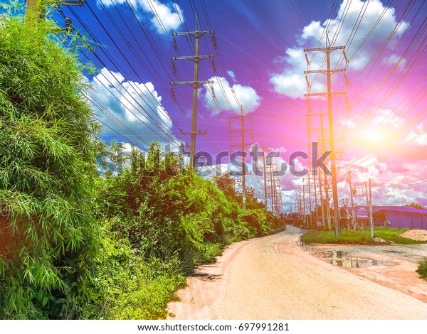 Roads\
and power pole along the road and beautiful\
sky.