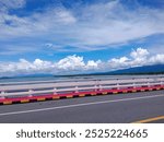 The roadside barrier and the bright sea