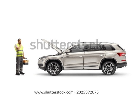 Roadside car mechanic holding a tool box and looking at a SUV with an open hood isolated on white background