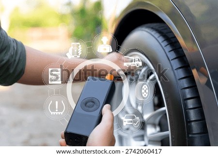 Roadside emergency problem-solving concept Man holding portable tire inflator to fix flat tire during travel,Contact online assistance center for support,Ensuring safe journey,24 hour roadside service