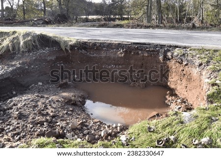 Roadside erosion of the B957 caused by the flooding of the South Esk river at Justinhaugh in Angus, Scotland, after Storm Babet in October 2023.