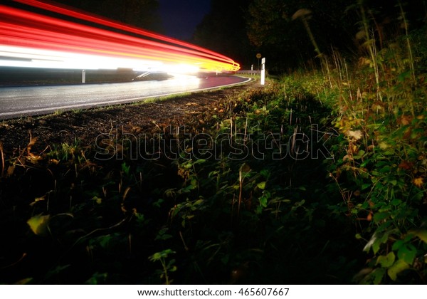 Roadside with light streaks\
from cars