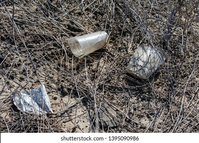 Roadside Litter Of Cups And Plastic Covered In Dirt And Debris.