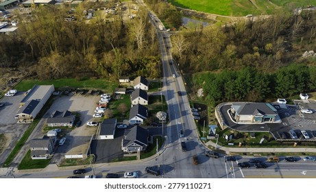 Roadside mixeduse strip captures homes, small commercial pads light industrial frontage along White Marsh corridor with wooded buffers nearby waterway, Maryland. USA