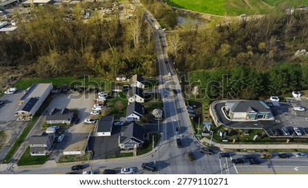 Roadside mixeduse strip captures homes, small commercial pads light industrial frontage along White Marsh corridor with wooded buffers nearby waterway, Maryland. USA