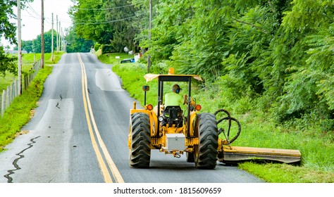 Roadside mowing by county maintenance worker near intercourse, PA. - Shutterstock ID 1815609659