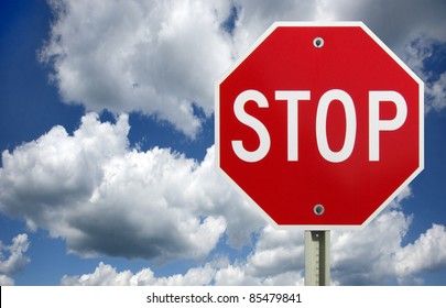 Roadside Red Stop Sign On A Cloudy Background. Sign Isolated.