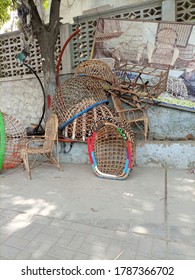 A Roadside Vendor Selling Wooden / Cane Furniture. Hanging Oval Garden Chair  - Karachi Pakistan - Jul 2020