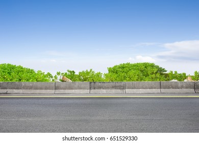 Roadside View And Shrubs On Blue Sky