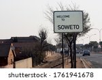 A roadside welcome banner inviting you to visit the Soweto area of JohannesburgRoad sign, road sign "Welcome to SOWETO" at the entrance to the suburb of Johanessburg - Soweto, South Africa. 