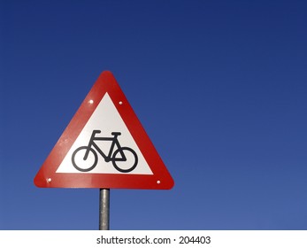 Roadsign - cyclist ahead on a clear bule sky