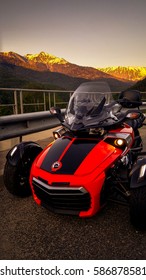 Roadster BRP Can-Am Spyder F3 On A Background Of Mountains On The Highway 