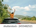 roadtrip concept from solo woman traveler stand from her car with relax and happiness feeling