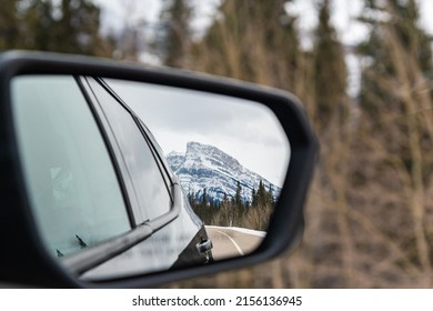 Roadtrip Views In Northern Canada During Winter From The Mirror Of A Car. 