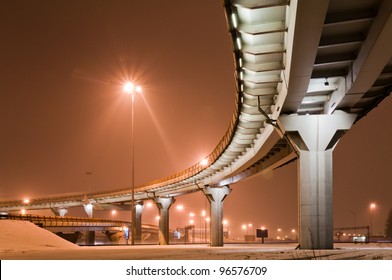 Roadway At Night, Sky Is Colored In Orange