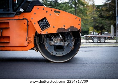 Roadwork and asphalt paving machine for road construction.