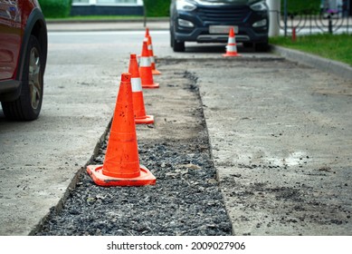 Roadwork, Driveway Repair, Prepare For Laying New Asphalt. Damaged Asphalt Road Surface Repairing. Preparing For Patch Works. Repair Pothole In Asphalt Pavement, Road Work Warning Cones.