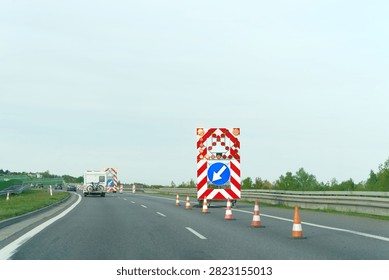 Roadwork scene with barriers and traffic redirection