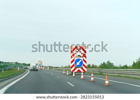 Roadwork scene with barriers and traffic redirection