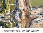 Roadworks construction site at roundabout intersection on American highway. Development of city circular transportation crossroads