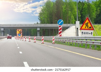 Roadworks, Large Bright Mobile Sign With Stripes, Detour Direction And Flashing Yellow Arrow On Road Service Truck Trailer In Right Lane On Highway