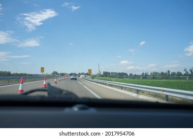 Roadworks on a highway divert traffic to a temporary road. View from the inside of the car