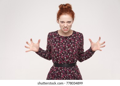 Roar! Anger ginger woman shout at camera. Bad emotions and feelings. Isolated on gray background - Shutterstock ID 778034899