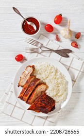 Roast Baby Back Pork Meaty Ribs With Basmati Rice On Plate  On White Wooden Table, Vertical View From Above