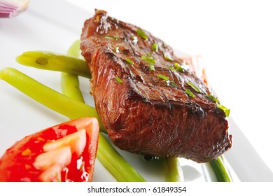 roast beef fillet served with tomato on white