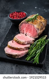 Roast Beef Fillet Tenderloin Meat On A Marble Board. Black Background. Top View