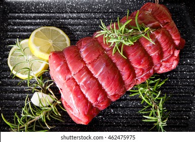 Roast Of Beef With Rosemary On Plate Pot On Black